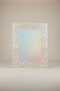 High-end studio product shot of a large rectangular wall mirror with a thick white floral bone inlay frame on a clean beige background. Front-facing view, glass reflecting a soft gradient. Soft studio lighting, sharp focus, minimal shadows, luxury catalog style, 8K.